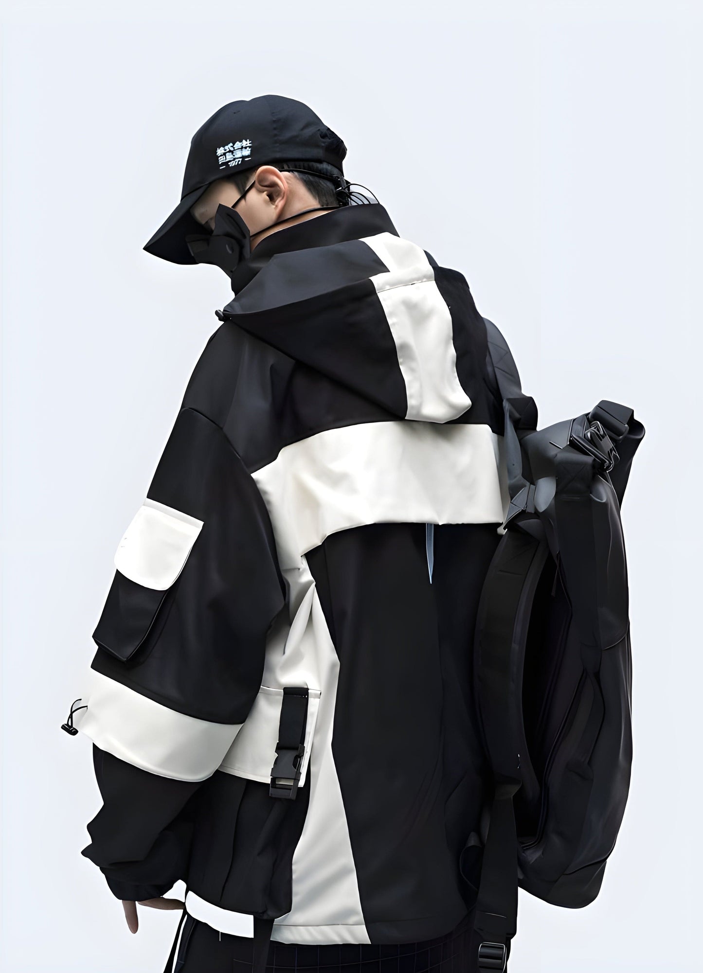 Back view of a man sporting a trendy techwear kanji windbreaker with Japanese text, ideal for UK customers seeking an edgy look.