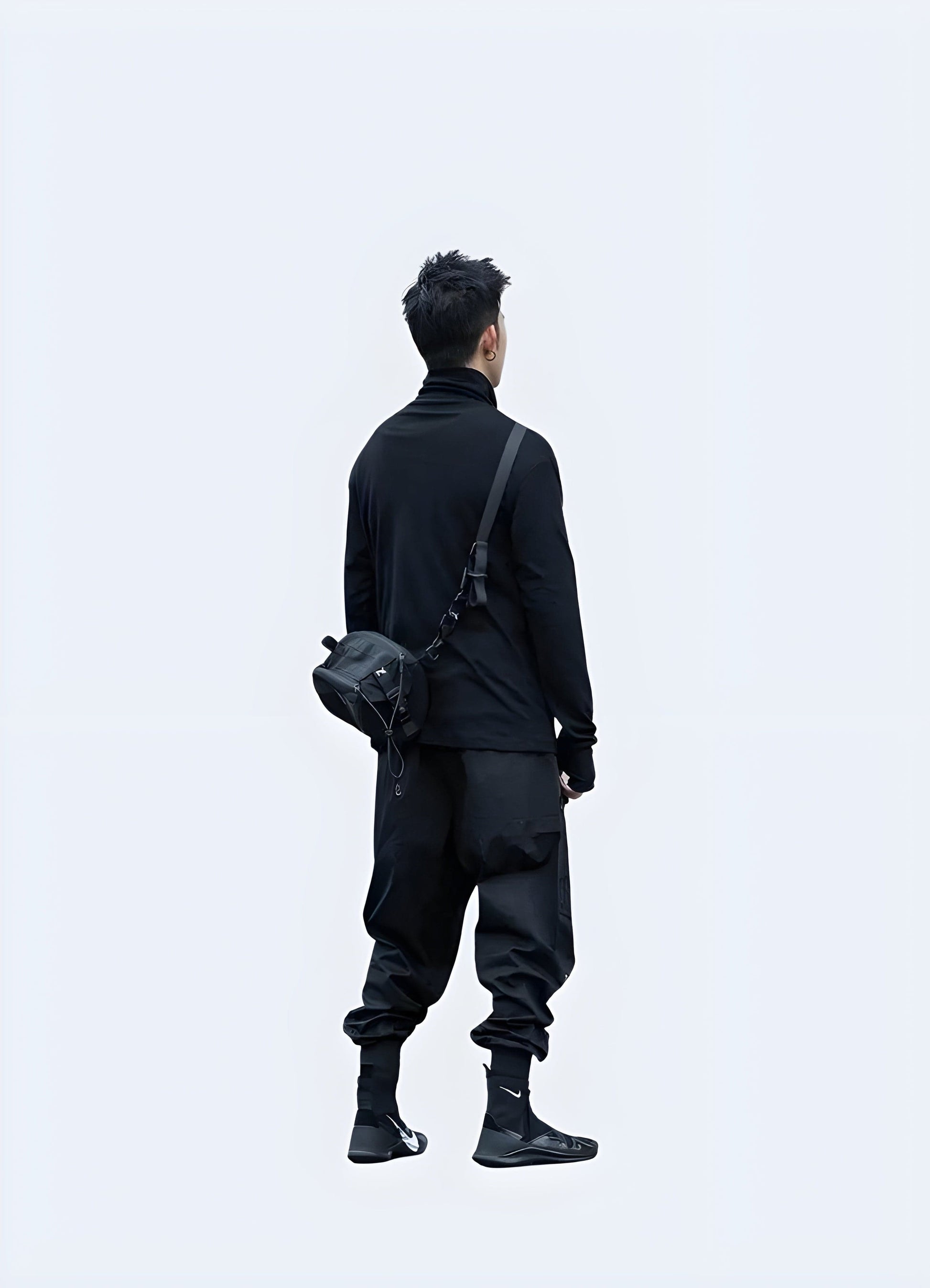 Back side view of a man sporting a techwear long sleeve shirt, highlighting its advanced materials and ergonomic fit, perfect for those who demand the best in fashion and functionality in the UK.