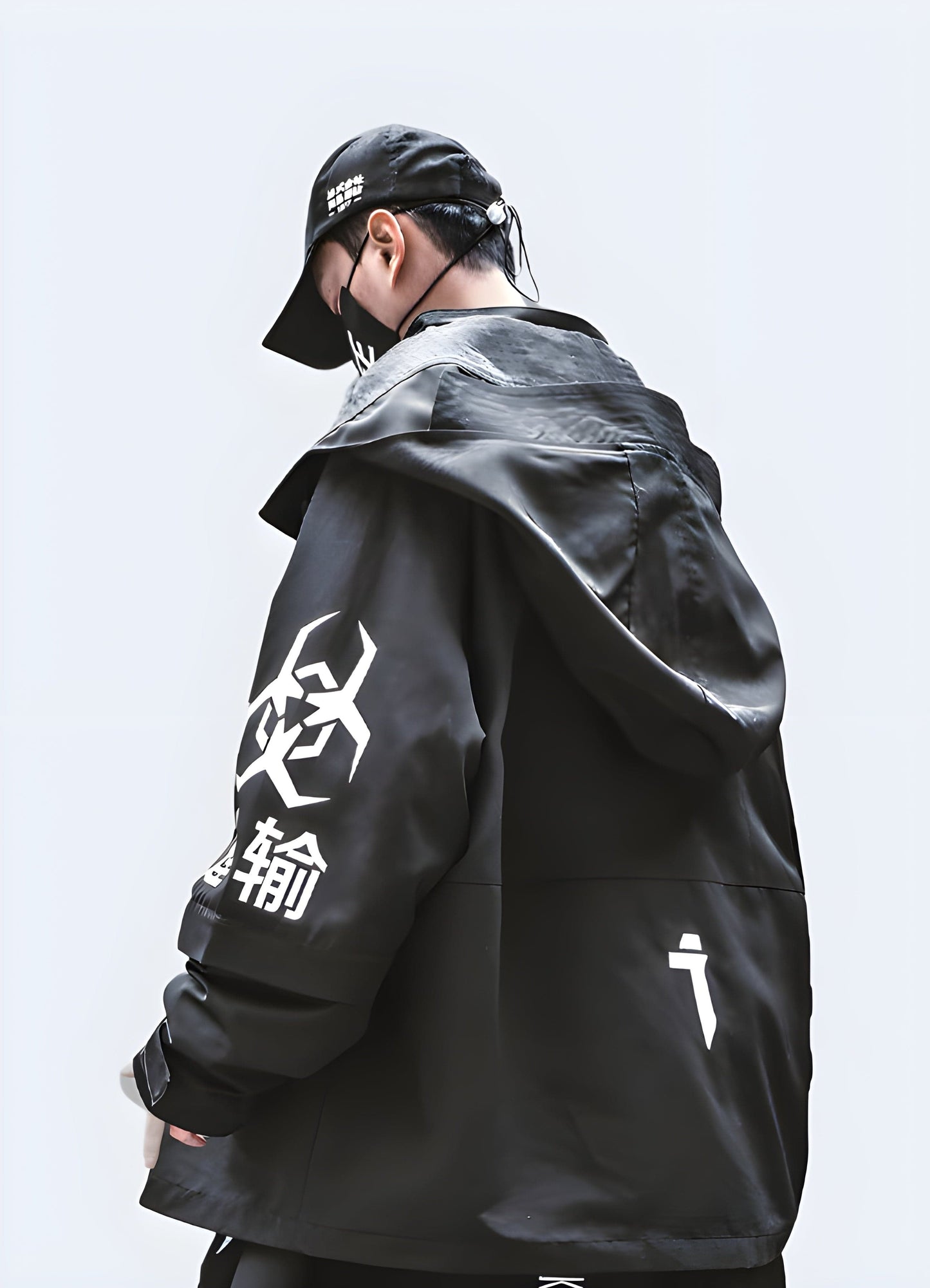 Back view of a man wearing a techwear oversized jacket, showcasing its unique silhouette and advanced features, perfect for UK's urban fashion scene.