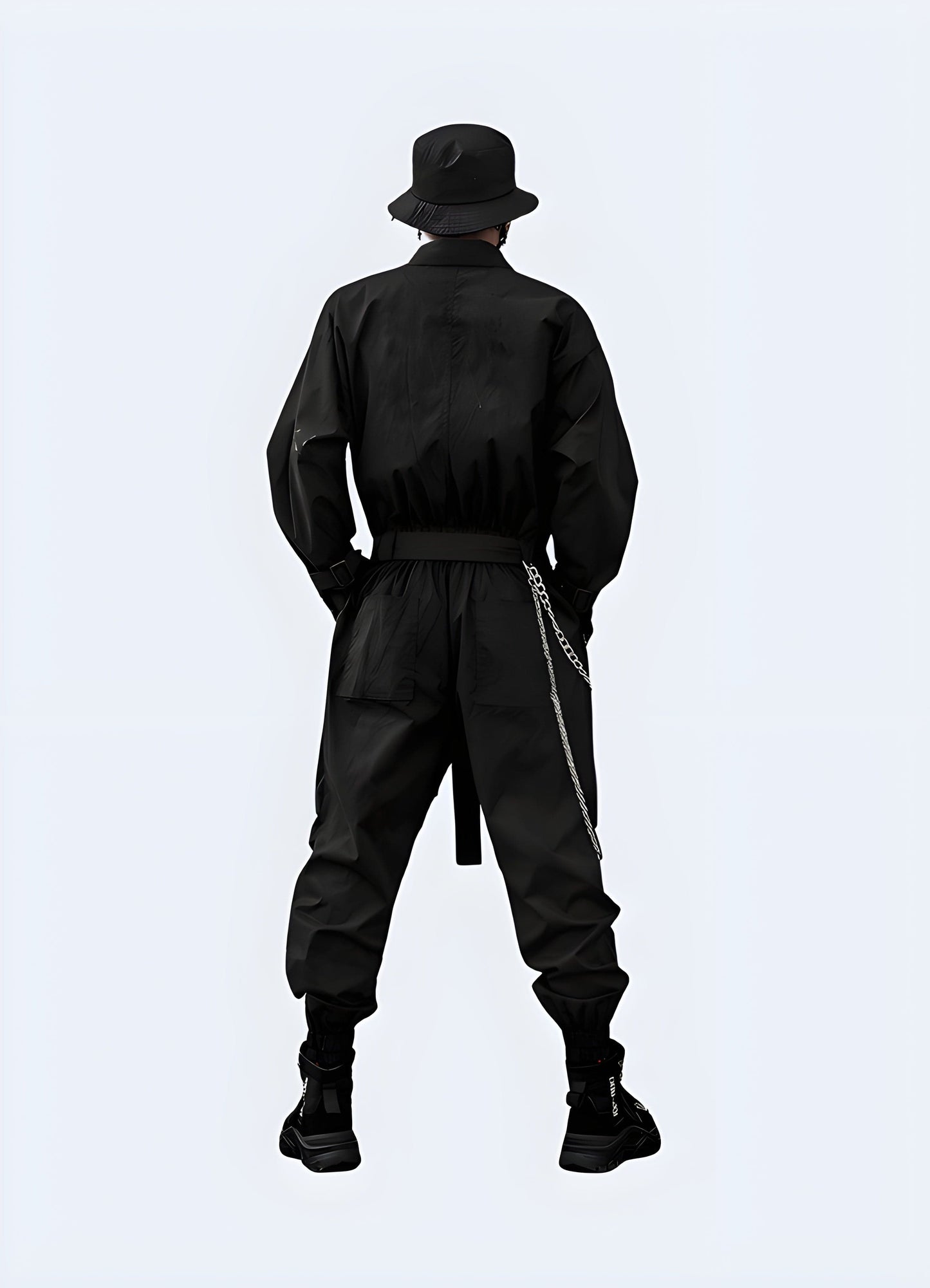 Back view of a man wearing a sleek black techwear tracksuit, showcasing the garment's streamlined fit and technical details for enhanced performance in the UK.