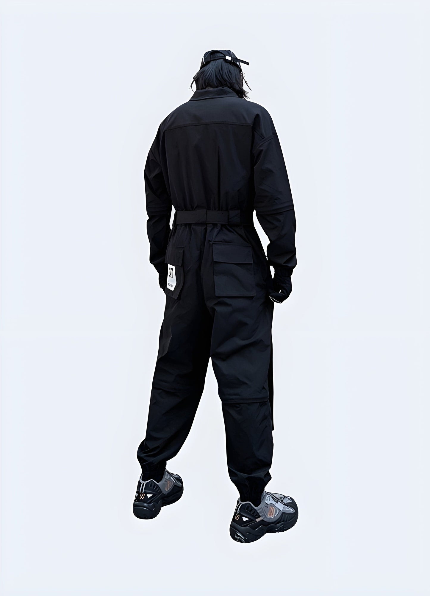 Back view of a man wearing advanced techwear workwear in black, showcasing the garment's ergonomic fit and practical features for demanding work environments in the UK.