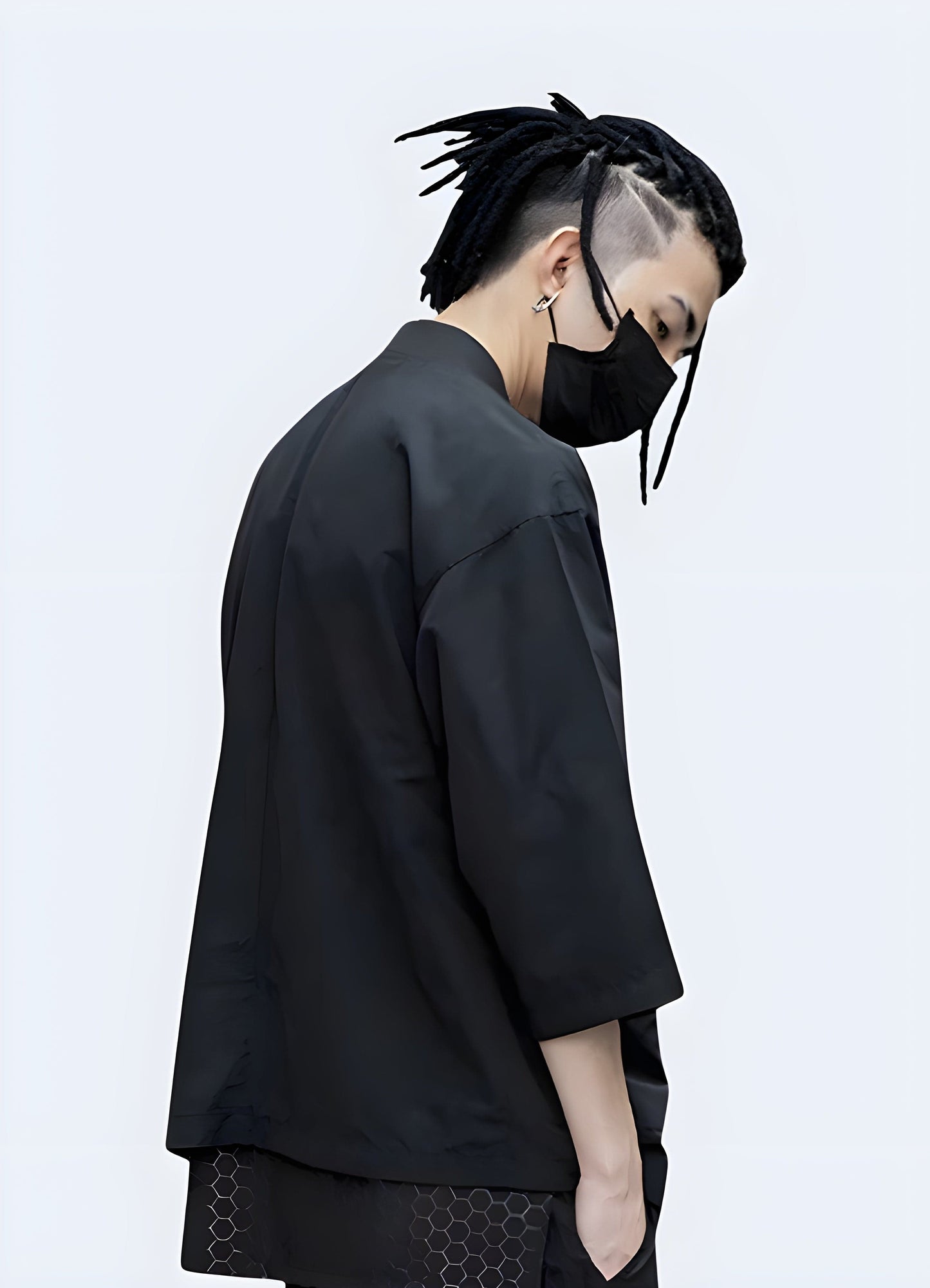 Model showcasing the back view of a modern urban kimono in the UK, featuring a contemporary twist on the traditional Japanese garment, with a sleek, minimalist design and high-quality fabrics.