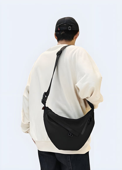 Man wearing an urban sling flat bag, back view, modern and trendy style in the UK