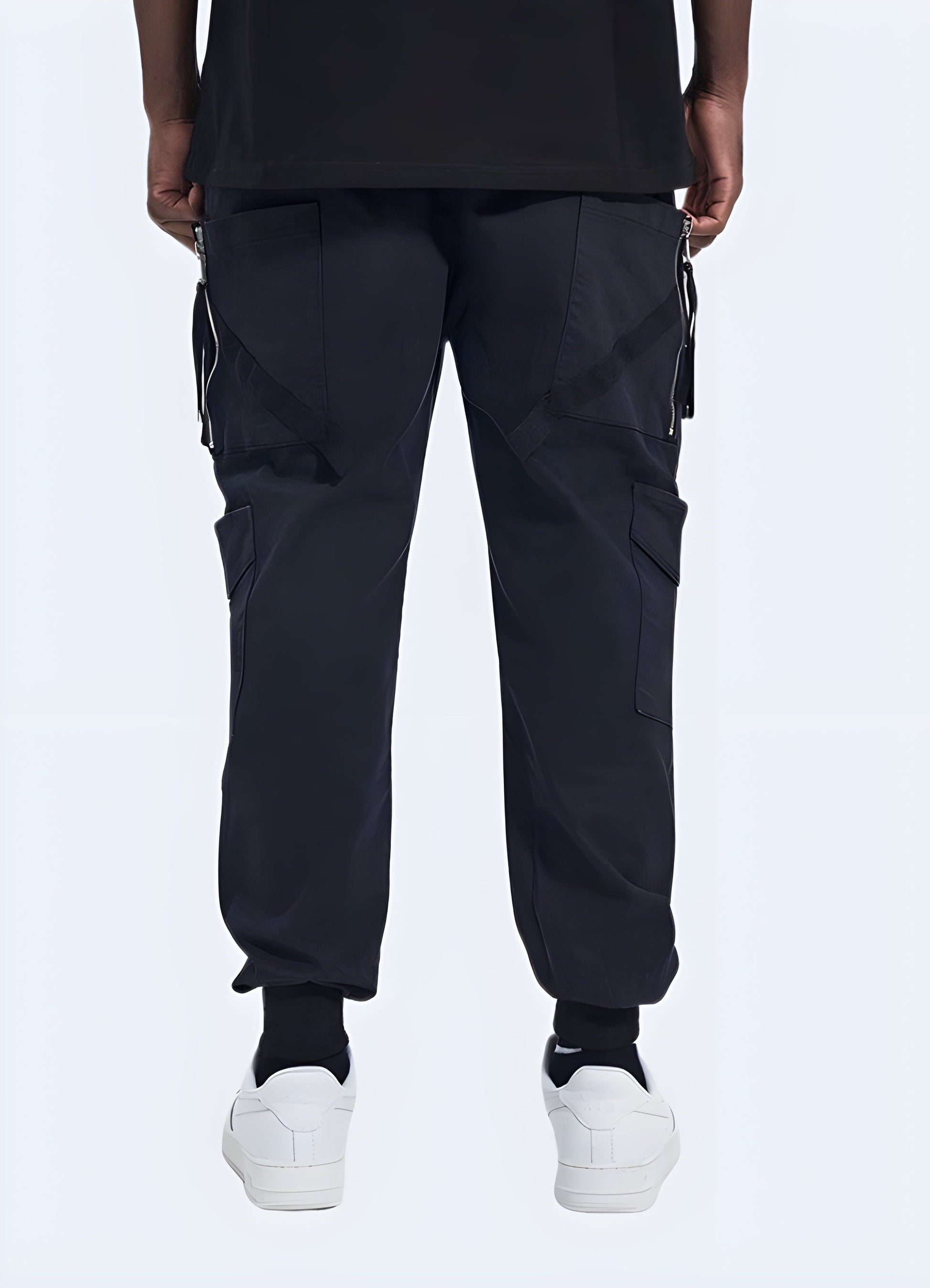  Back side view of a man wearing sturdy utility pants, emphasizing the garment's reinforced stitching and functional design, a must-have for UK consumers seeking durability and style.