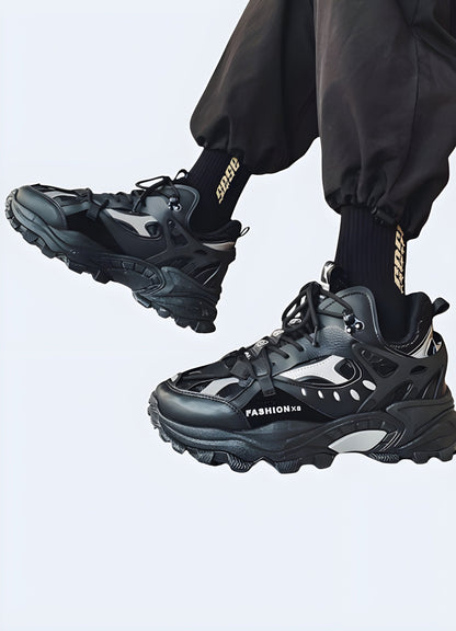 Fashionable male model showcasing trendy warcore boots in black leather with silver detailing, capturing the essence of alternative fashion popular among UK consumers.