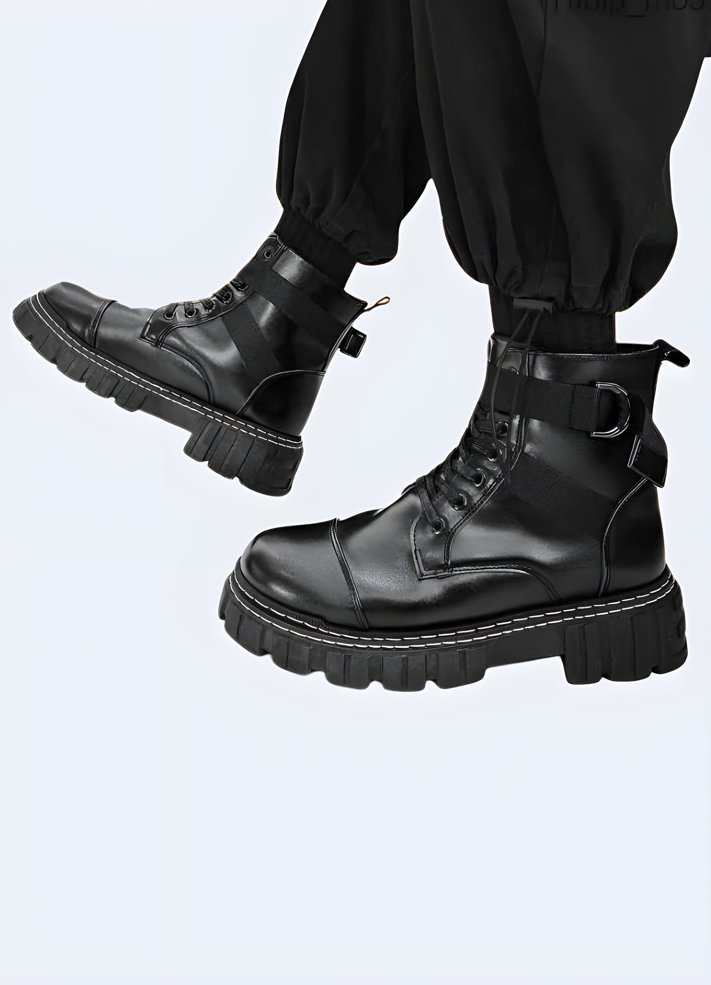 Side view of a man wearing black reflective techwear boots, demonstrating the comfortable fit, advanced technical features, and eye-catching reflective details ideal for tech-savvy fashion enthusiasts.