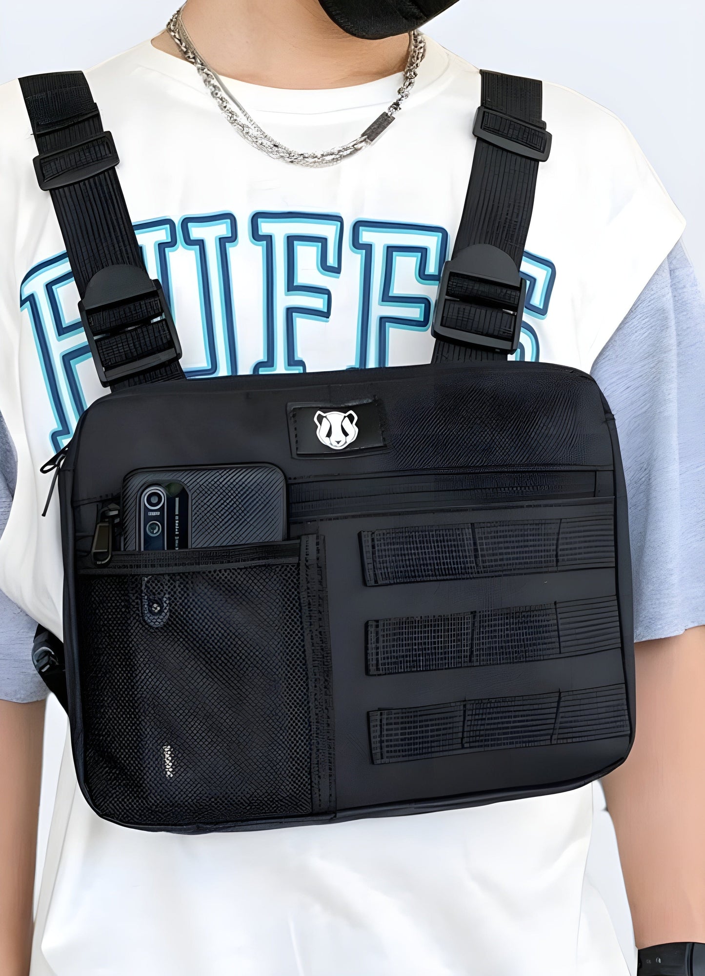 Man wearing chest utility bag, front view with model, UK. Modern and functional design.