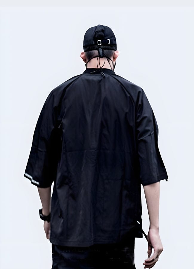 The back view of a man wearing a futuristic kimono highlights the garment's innovative design, combining modern aesthetics with traditional Japanese elements. 