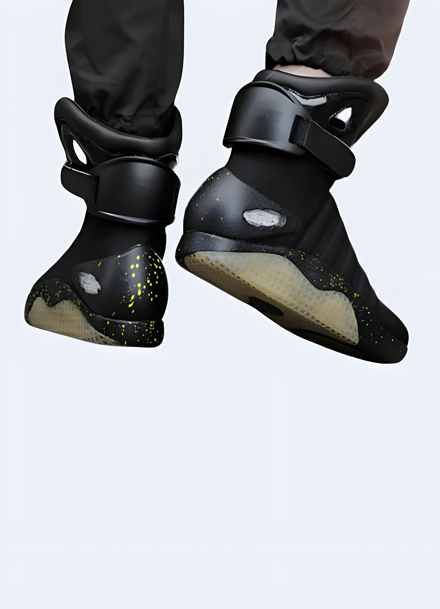 Men wearing high-top futuristic sneakers in black, back view in the UK. Modern and stylish look.