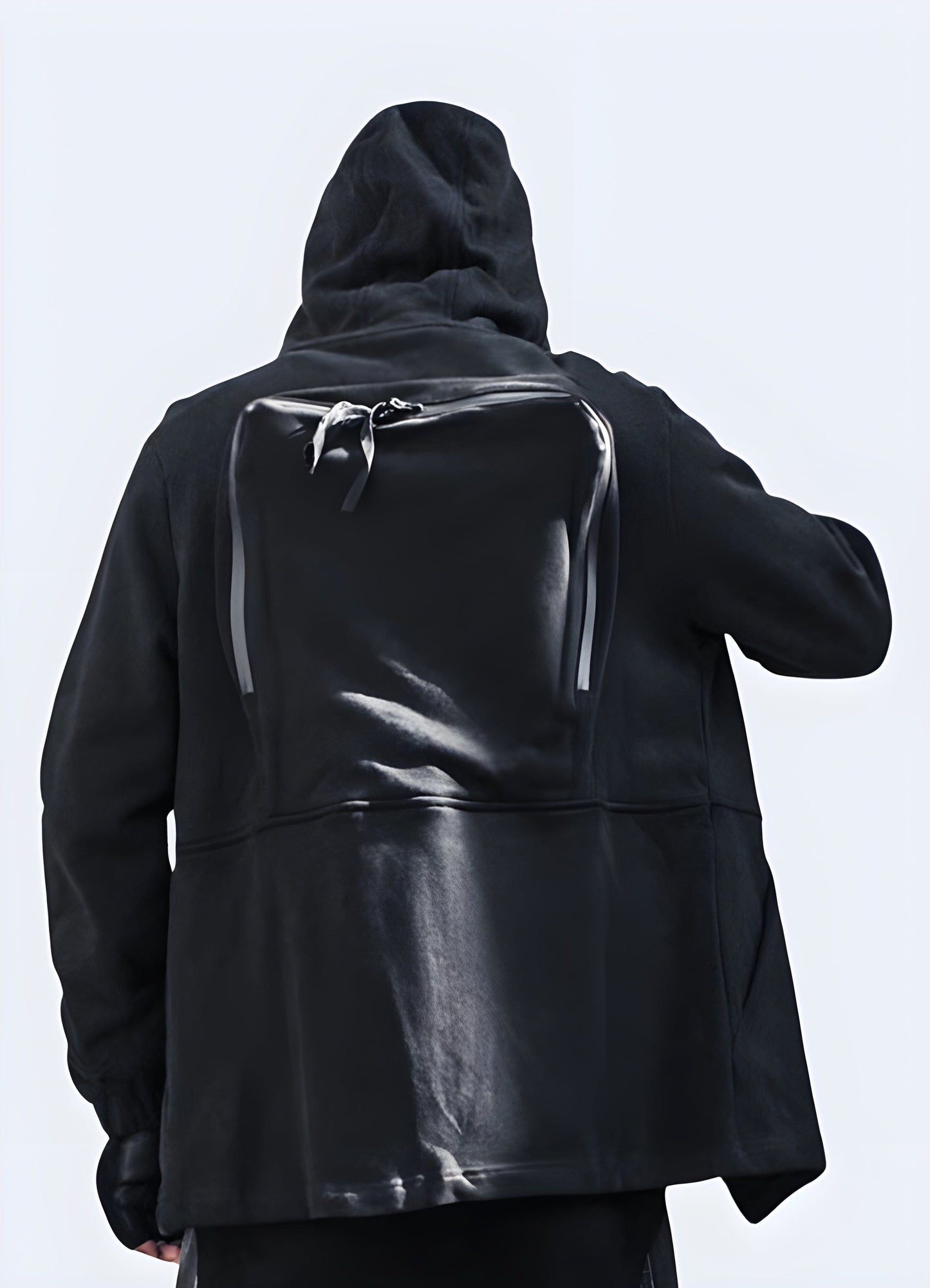 Back view of a man modeling a trendy Japanese zip-up hoodie in the UK, highlighting its unique design.