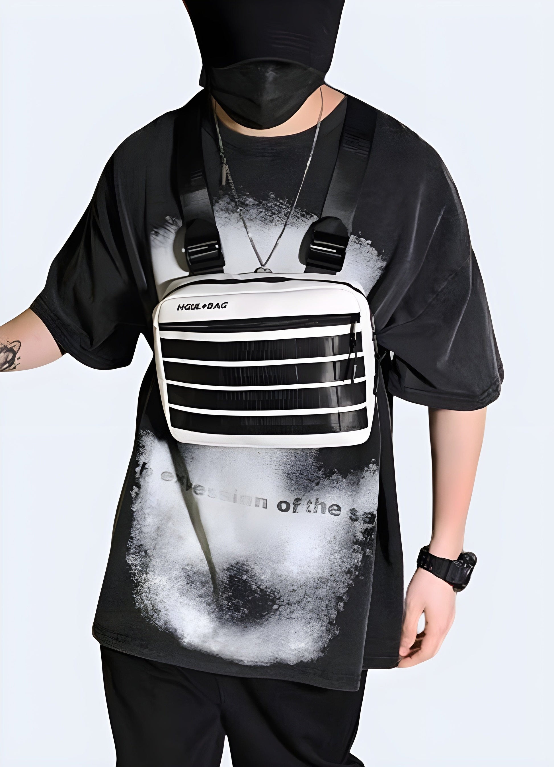 Man wearing large chest bag, front view with model, UK. Stylish and functional accessory.