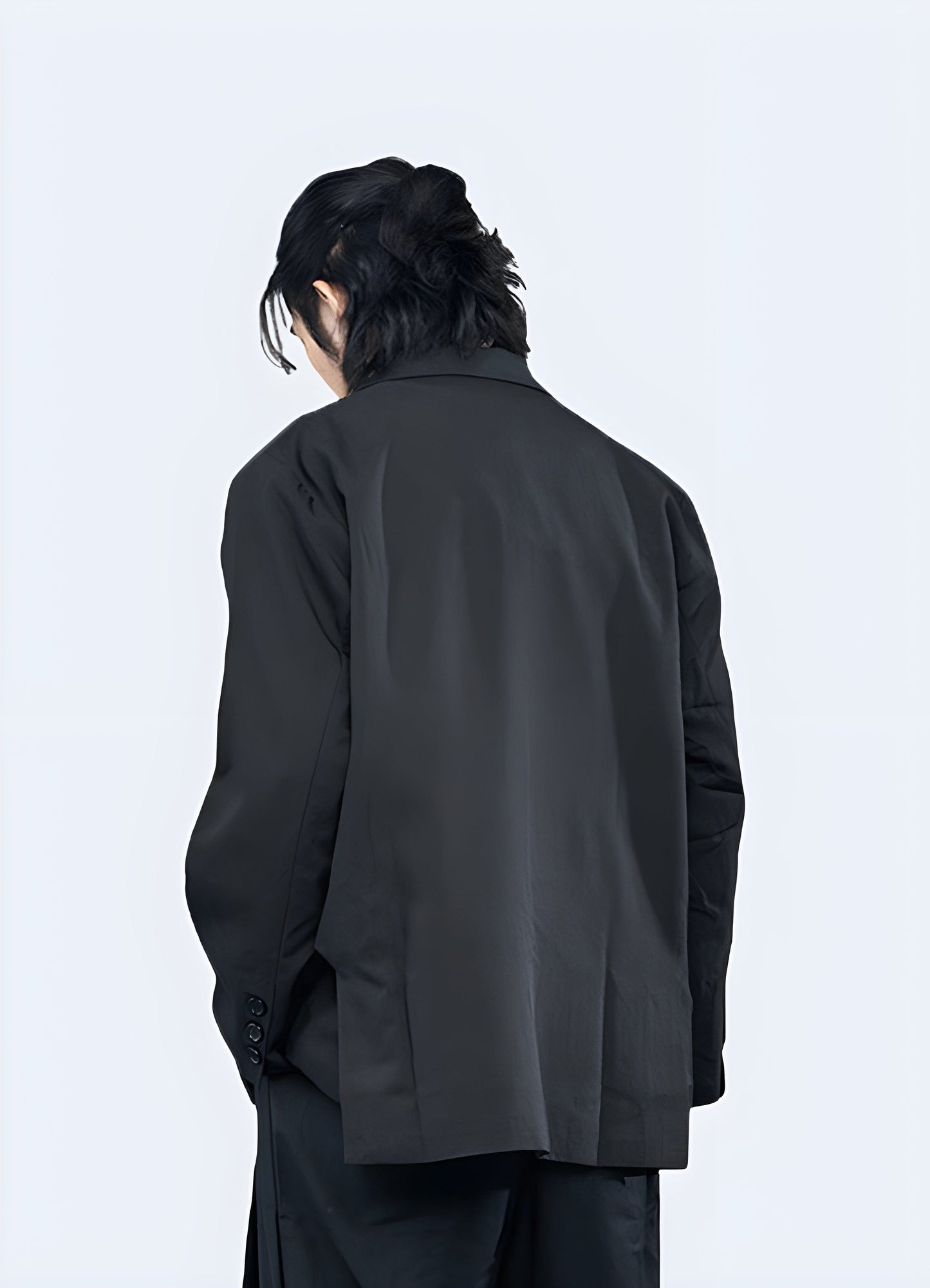 Back view of a man modeling a sophisticated minimalist blazer, ideal for UK professionals seeking a refined look.