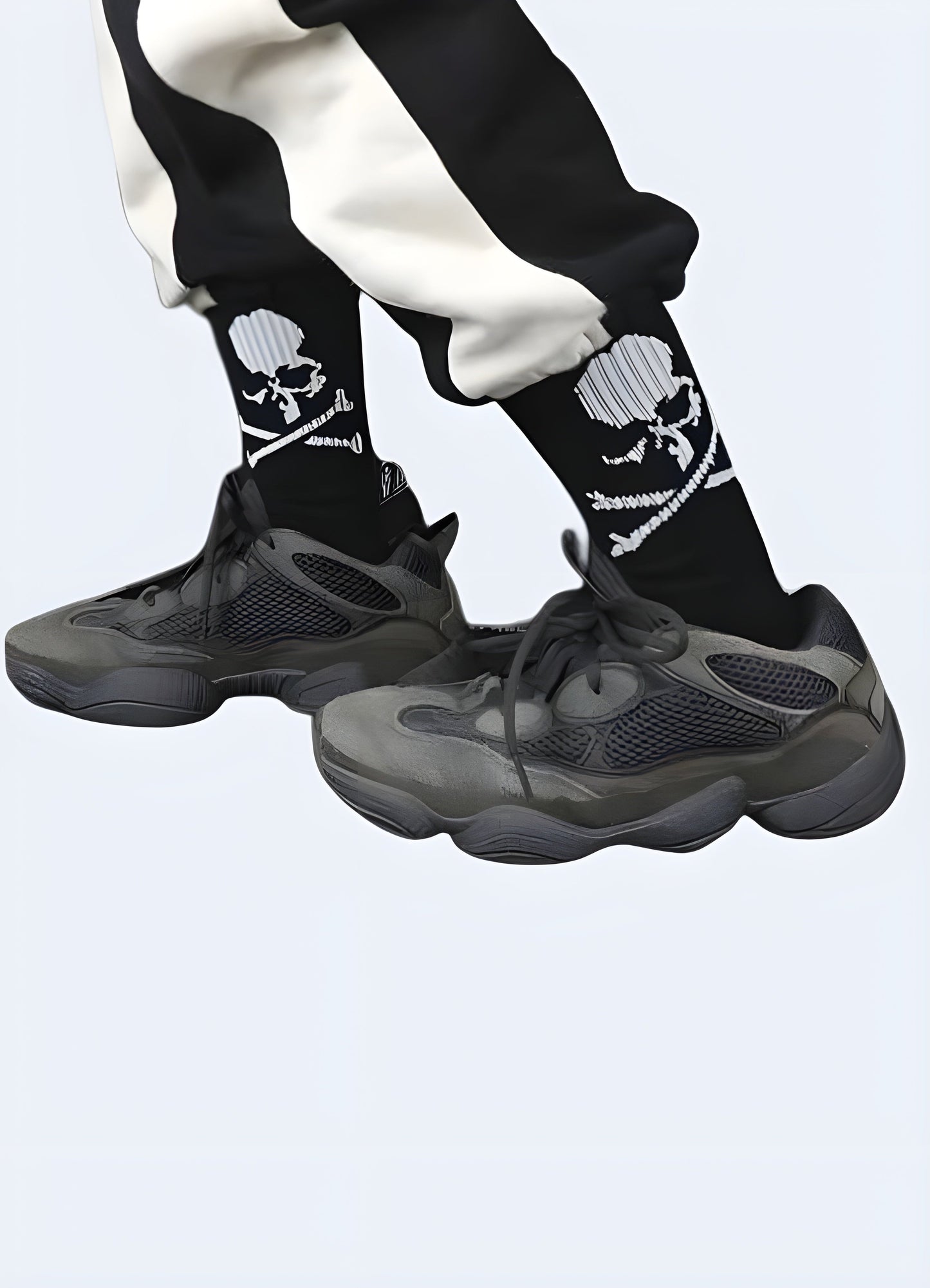 Side view of a man wearing black skull street socks in the UK. Edgy and fashionable sock design for men.