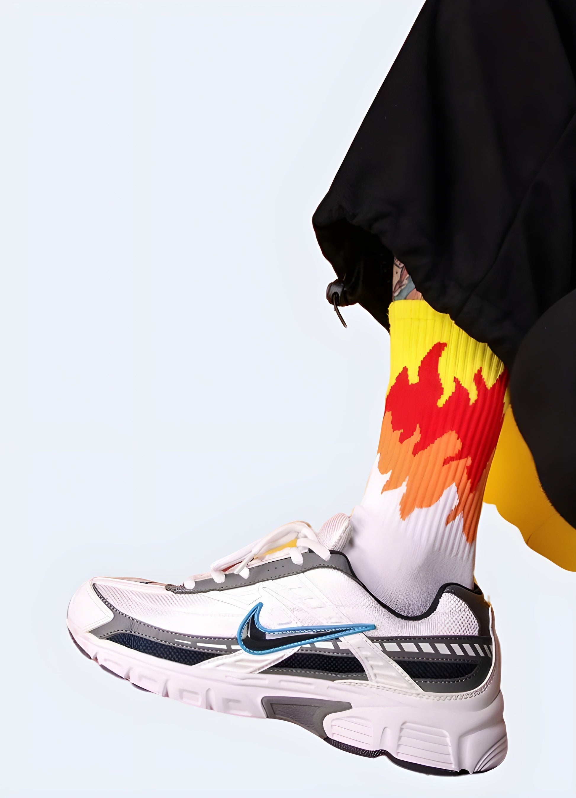 Men wearing white socks with striking flame designs, displayed from the side view, highlighting the trendy and daring style that caters to the tastes of UK streetwear fans.