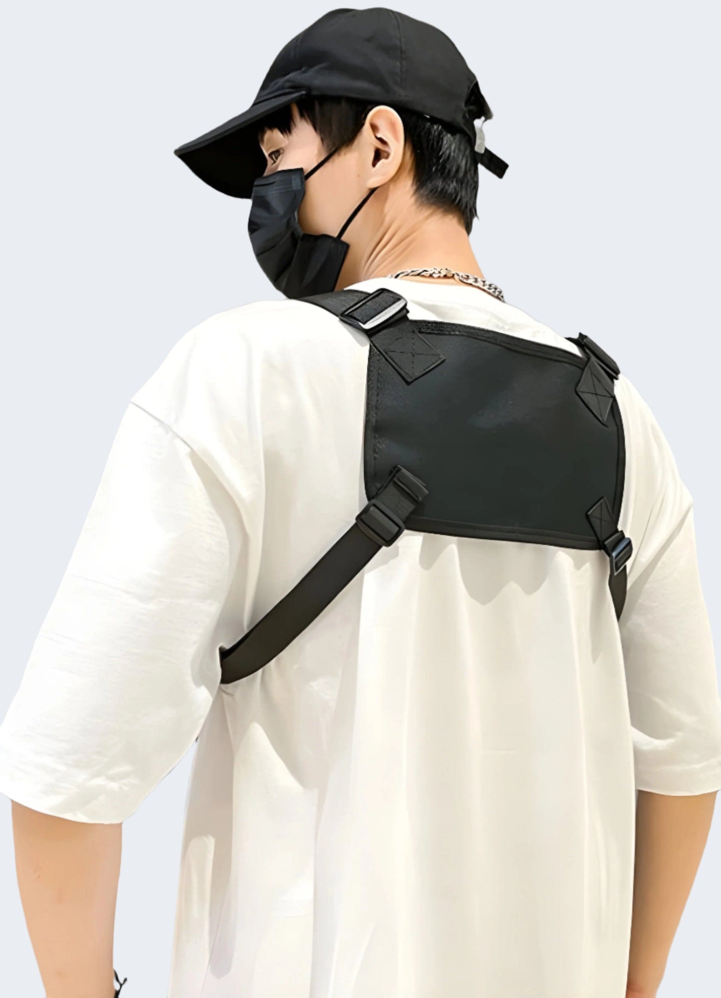 Man wearing TDYU black chest bag, back view, UK. Modern and functional design.