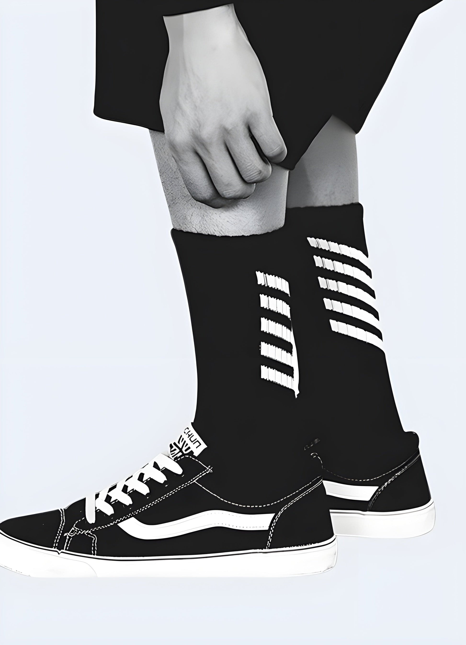 Side view of a man wearing black techwear-inspired streetwear socks, showcasing the sleek and modern style popular in the UK.