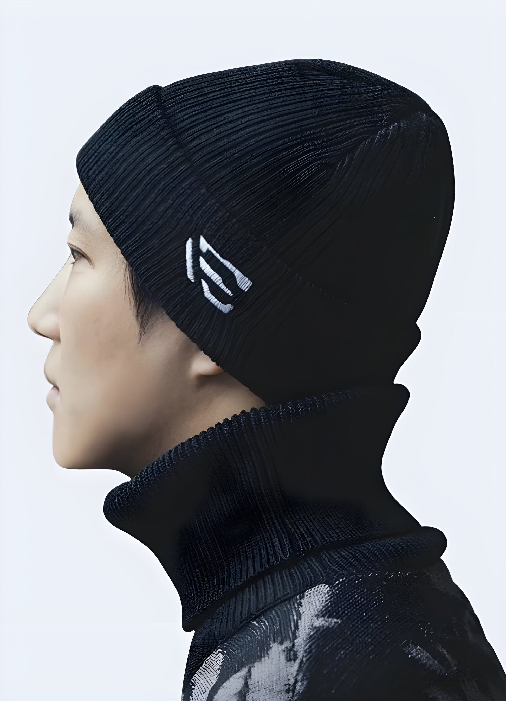 Side view of a man wearing a techwear knit beanie in the UK, highlighting its modern look and snug fit.