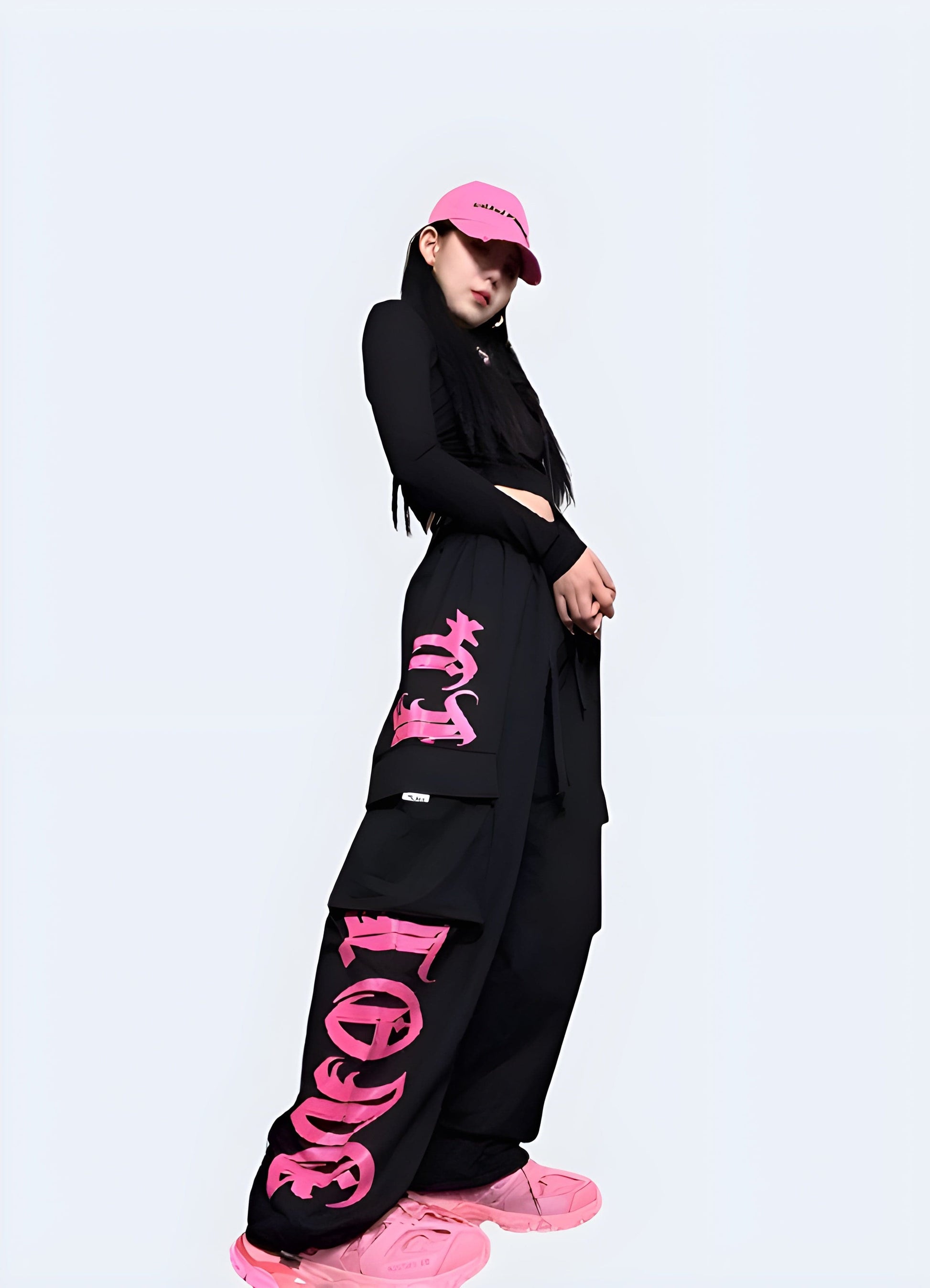 Right side view of a model wearing black and pink cargo pants, demonstrating the on-trend and versatile design that stands out in the UK fashion scene.