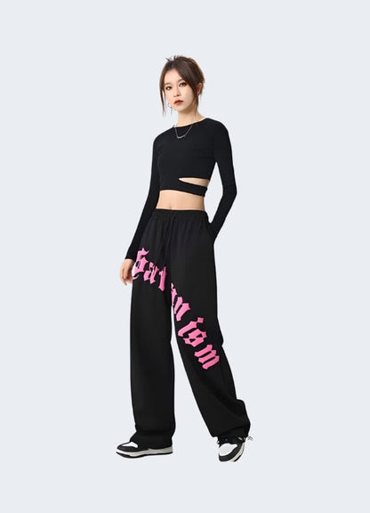 Right side view of a model wearing black and pink cargo pants, demonstrating the on-trend and versatile design that stands out in the UK fashion scene.