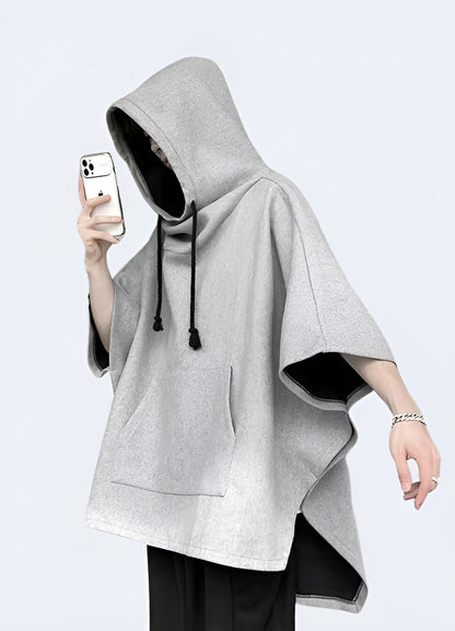 A front view of a light grey techwear poncho featuring multiple pockets, showcasing its sleek design and practical utility.