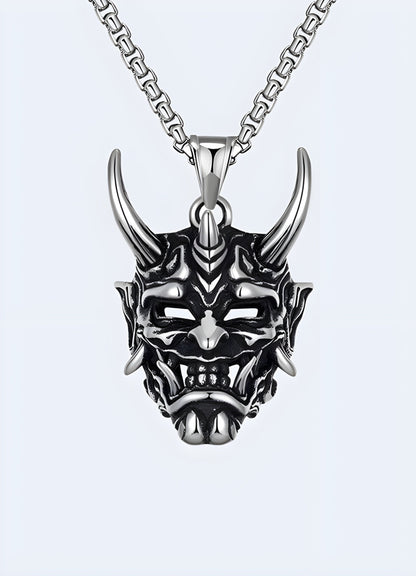 Silver oni mask necklace, UK, with intricate design and bold statement.