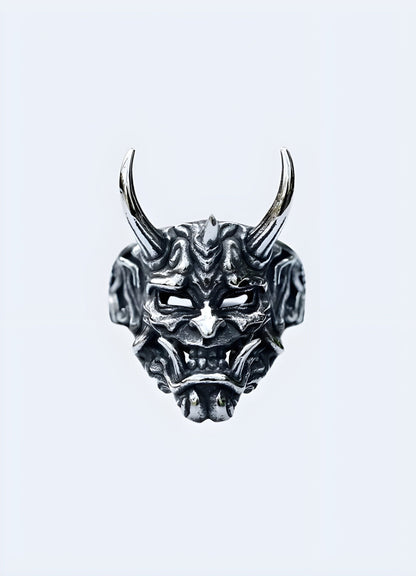 Oni ring in a front view worn by a model, UK, highlighting its detailed and striking appearance.