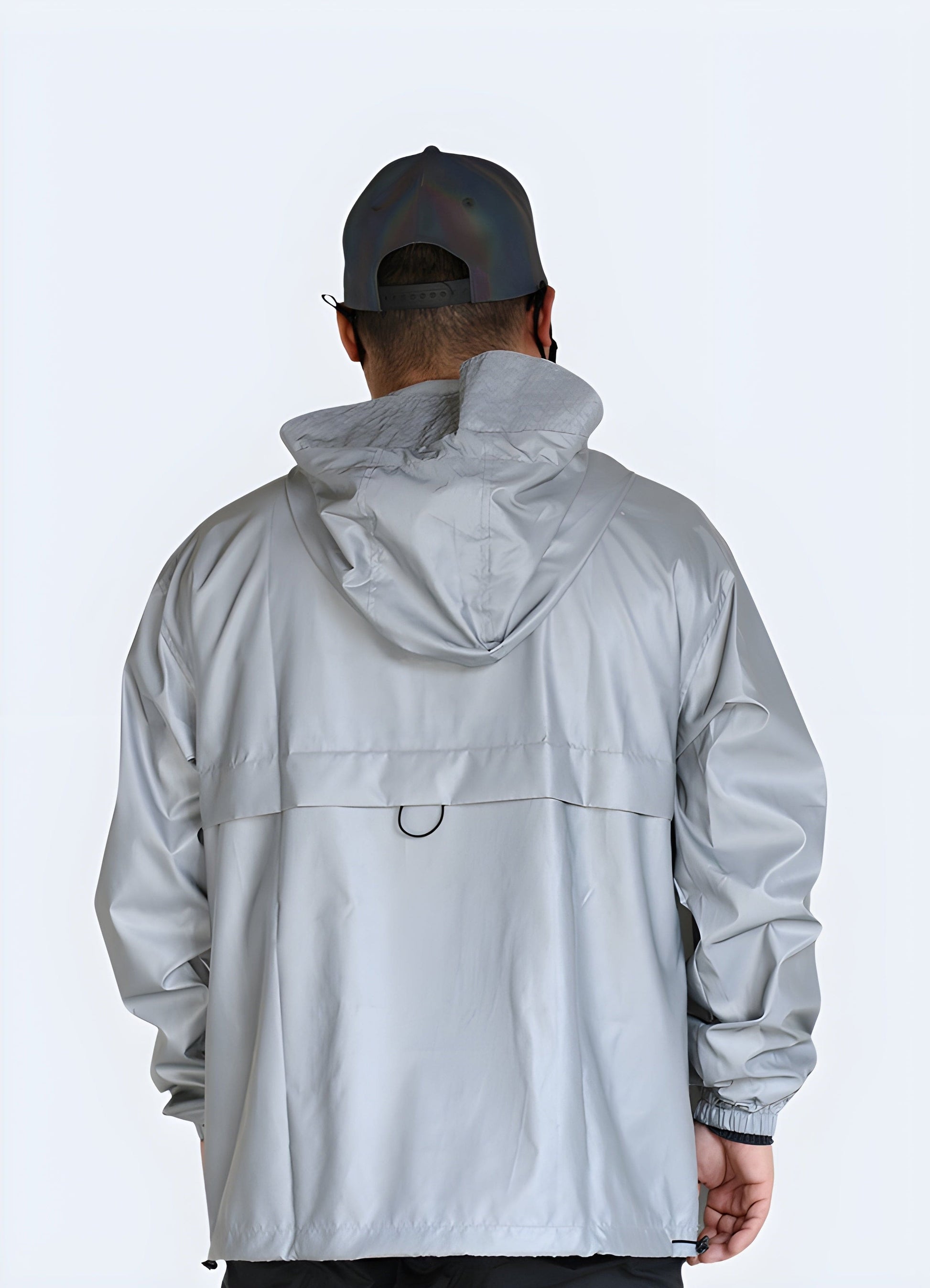 Back side view of a grey reflective jacket, emphasizing its modern silhouette, high-visibility reflective details, and versatile style, perfect for fashion-savvy individuals navigating UK's city streets.