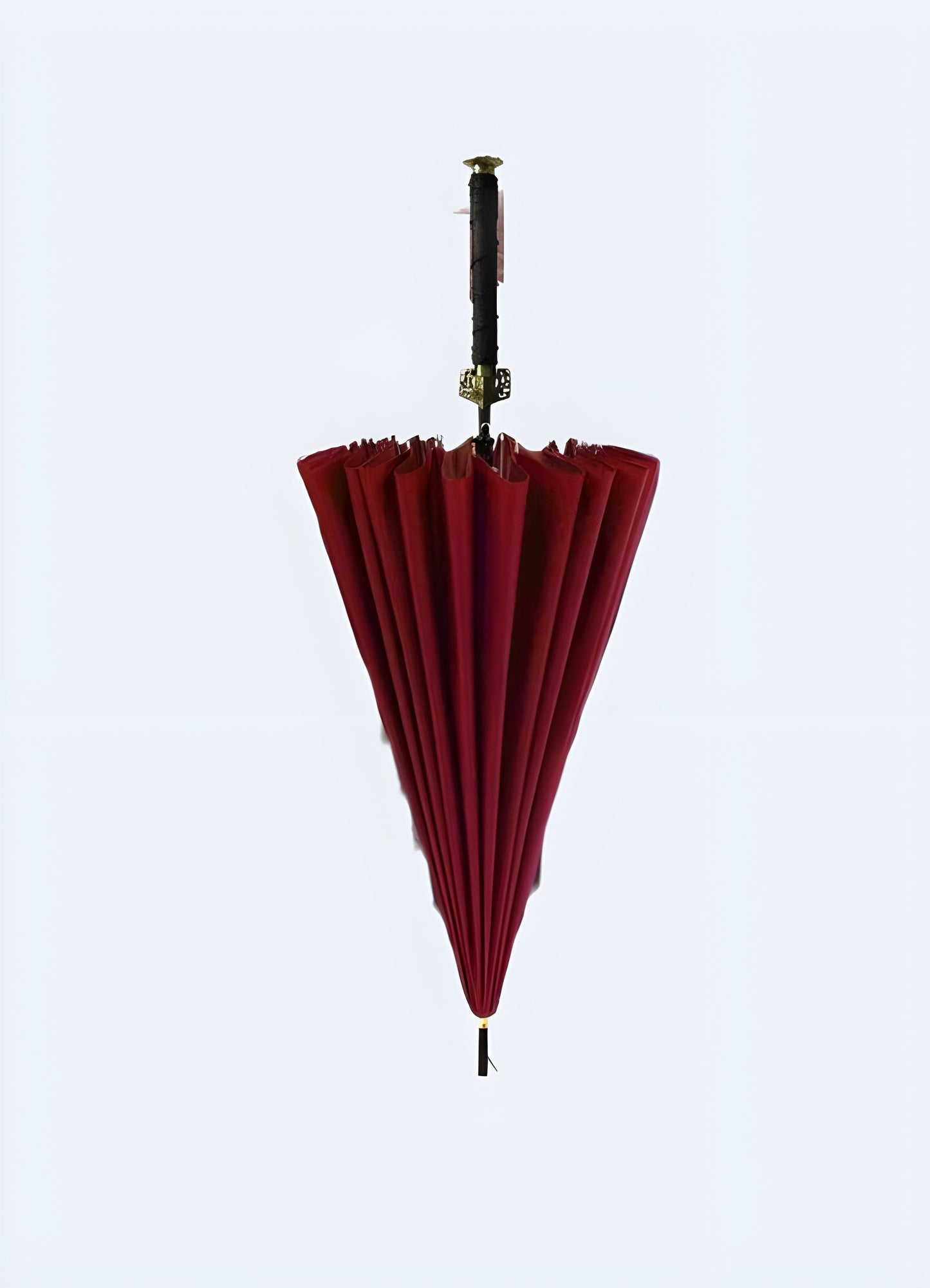 Samurai sword umbrella red front view. Front view of a red samurai sword handle umbrella featuring a bold, striking design, available in the UK.