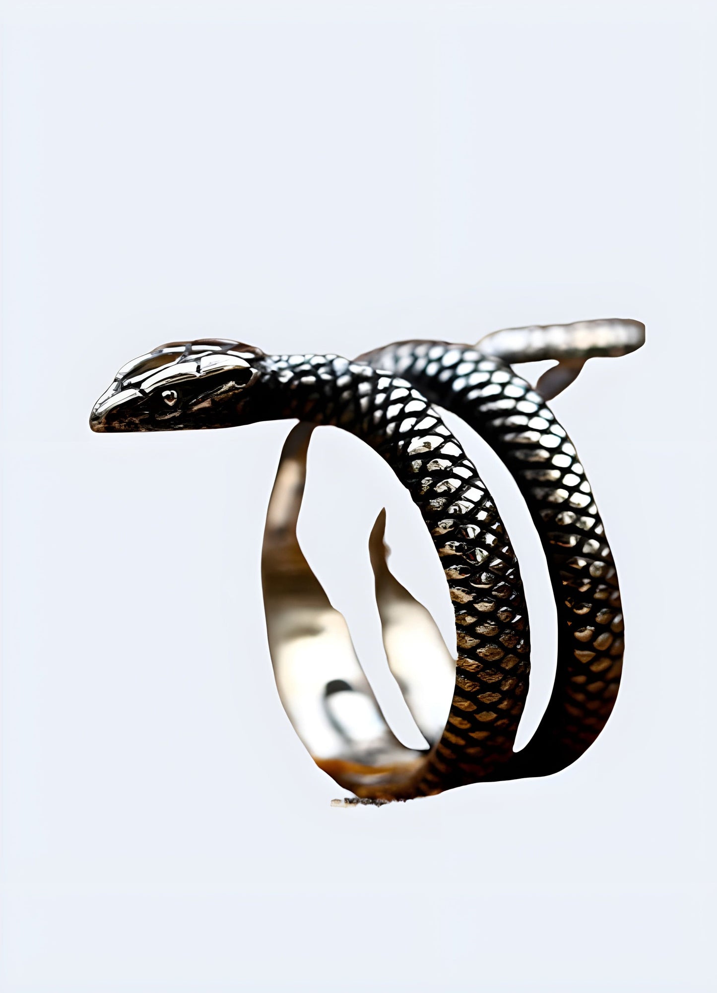 Silver snake ring in a side view worn by a model, UK, displaying its elegant and serpentine shape.