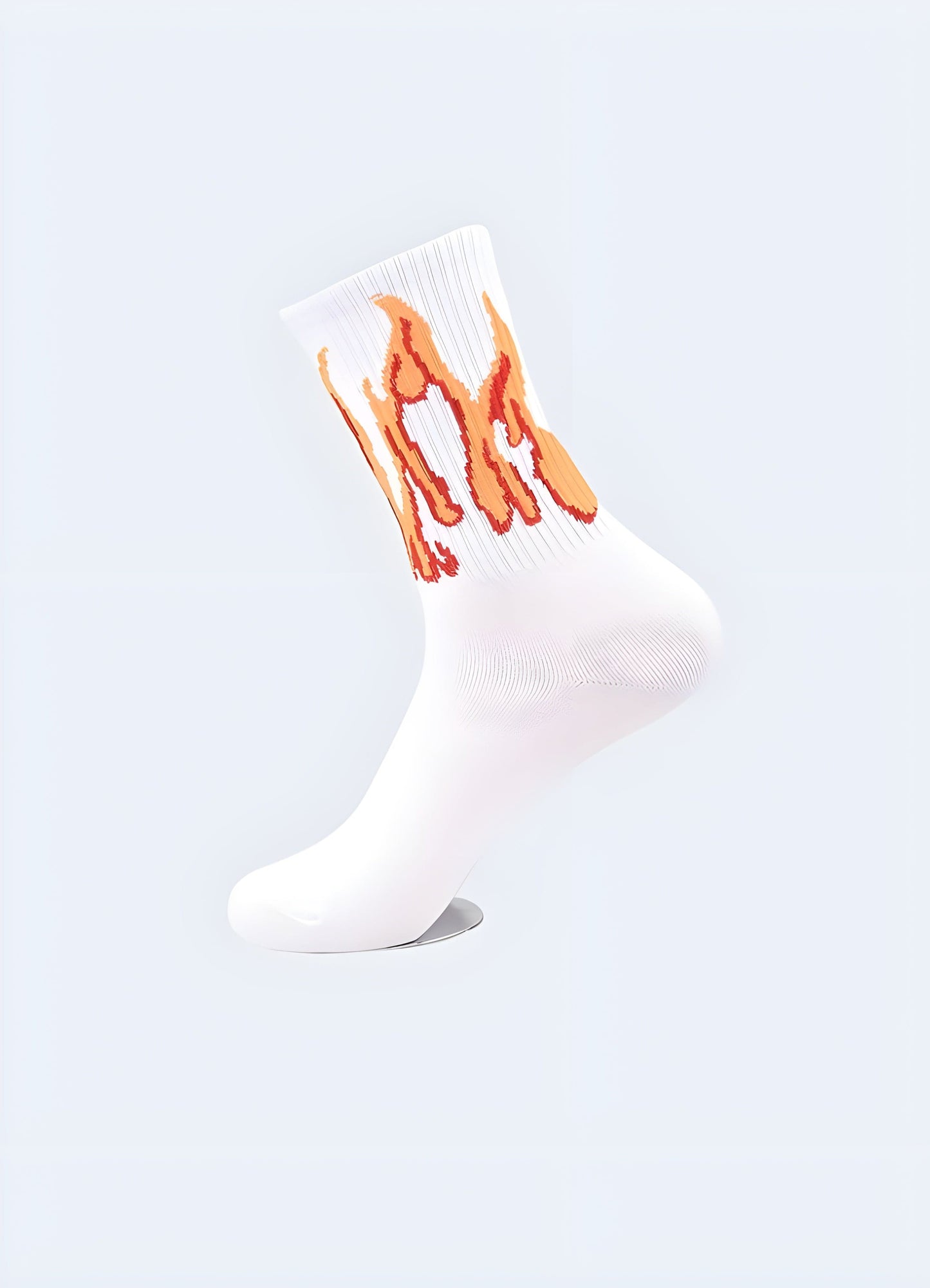 Side view of white socks featuring vibrant flame patterns, showcasing the eye-catching design that appeals to UK fashion enthusiasts seeking a bold statement piece.