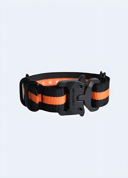 Techwear buckle bracelet in black and orange, UK, displayed from the front view, showcasing its bold color contrast.