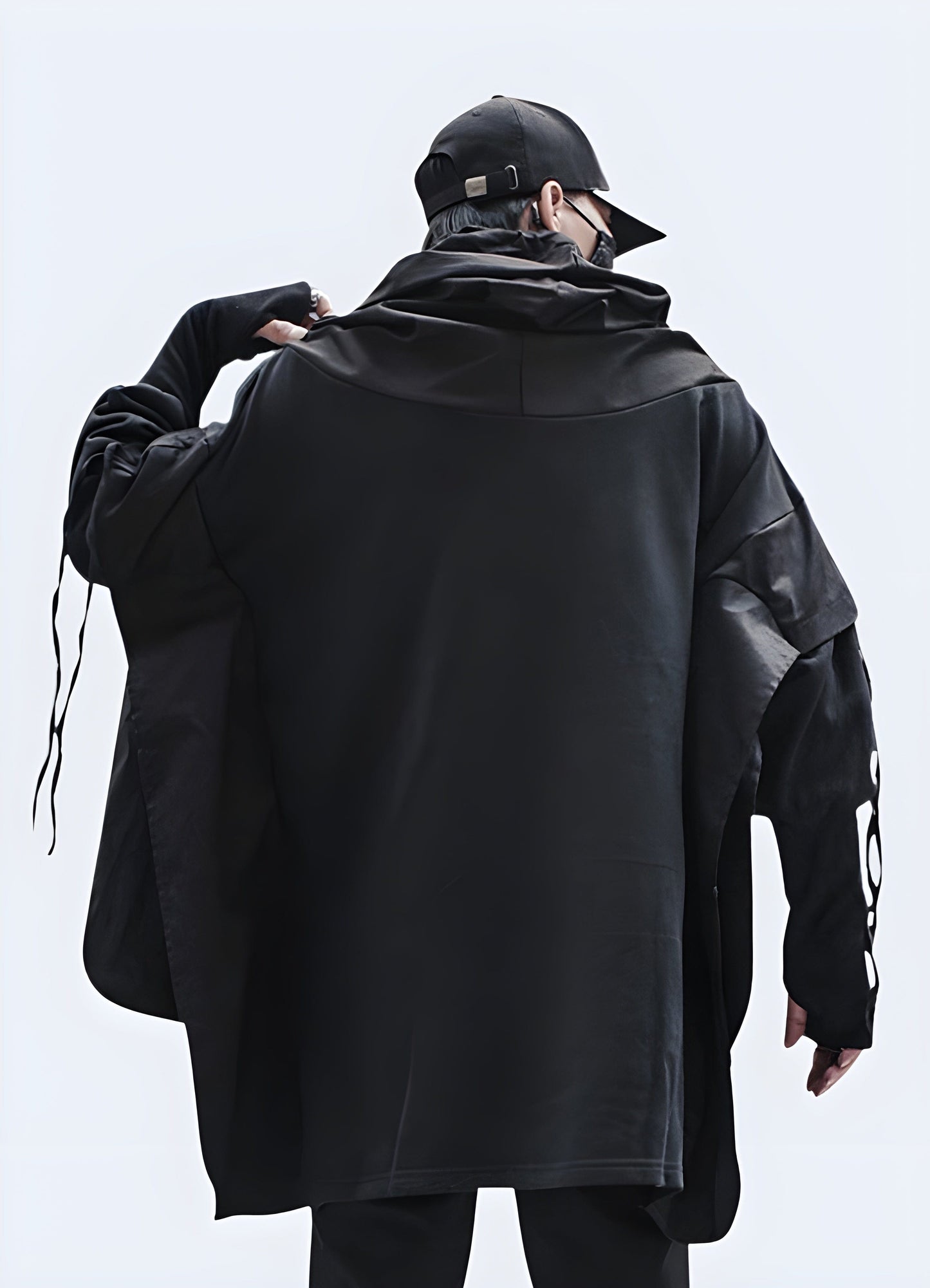 Back and side view of a man wearing a stylish techwear dark hoodie, showcasing its cutting-edge design in the UK.