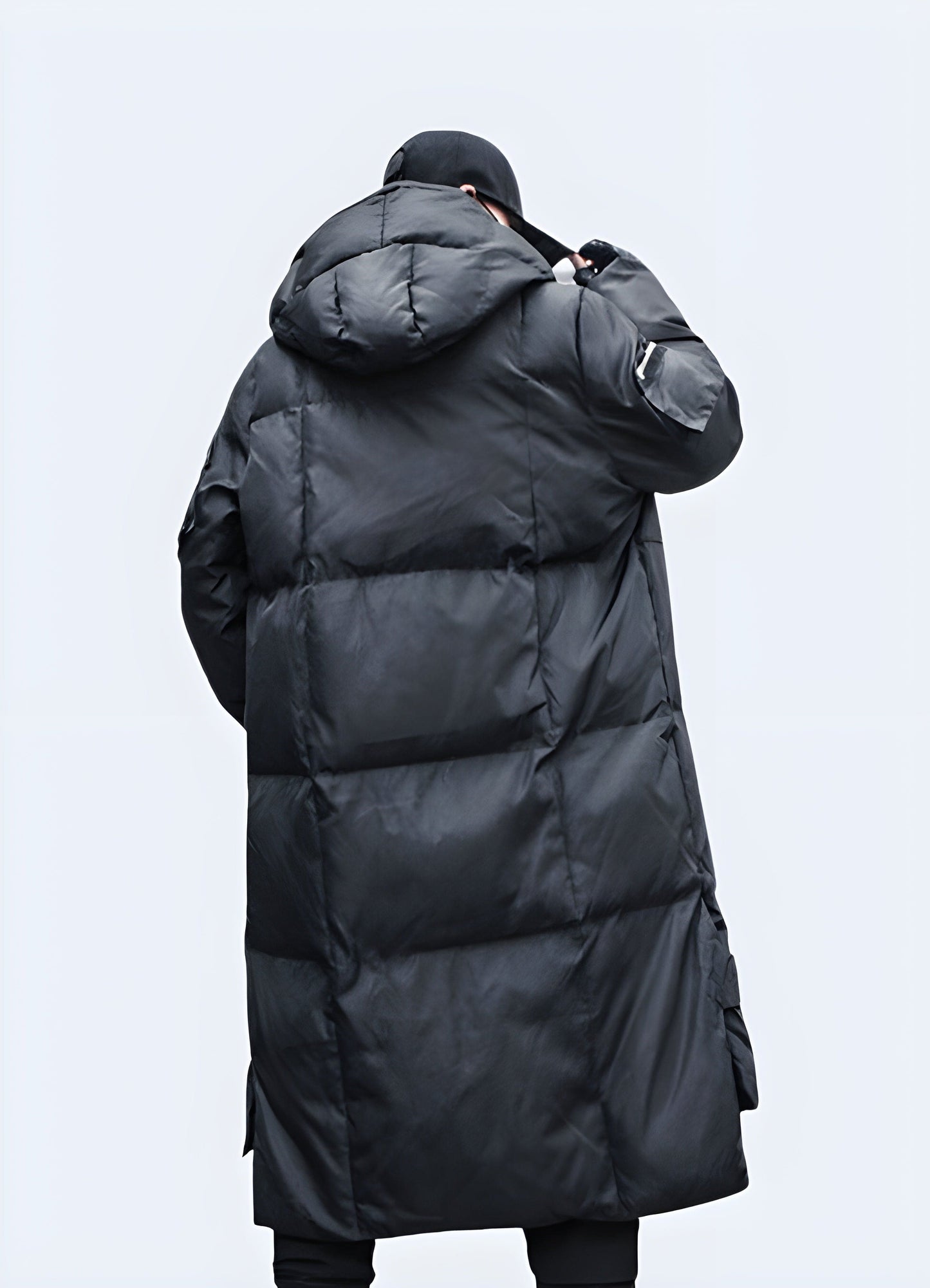 Back view of a men's techwear parka, providing all-weather protection for urban environments in the UK.