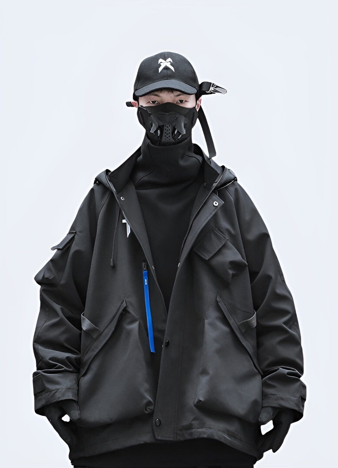 Front view of a man wearing a black techwear rain jacket, designed for urban weather protection in the UK.