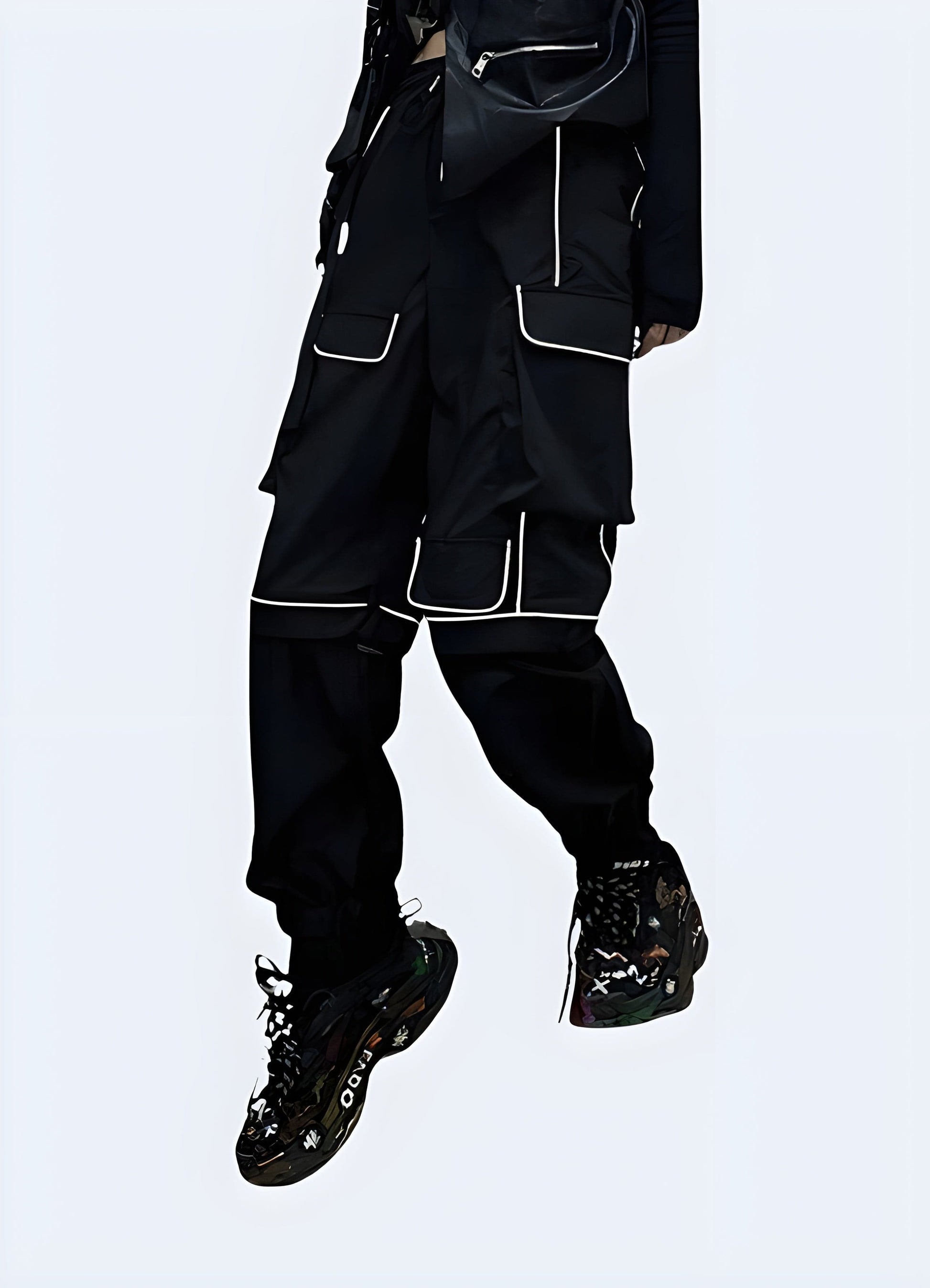 Front view of a woman wearing black reflective cargo pants, highlighting the techwear aesthetic and functionality for urban exploration in the UK.