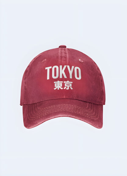 Red Tokyo Japan trucker cap with a white logo, side view. Eye-catching accessory for fashion-forward individuals.