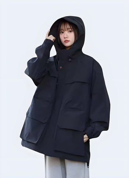 Front view of a model wearing a hooded cargo jacket, showcasing its streamlined silhouette, functional hood, and multiple storage options, ideal for fashion-forward individuals in the UK looking for a stylish and practical jacket.