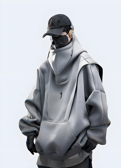 Front view of a woman wearing an oversized grey techwear hoodie in the UK.