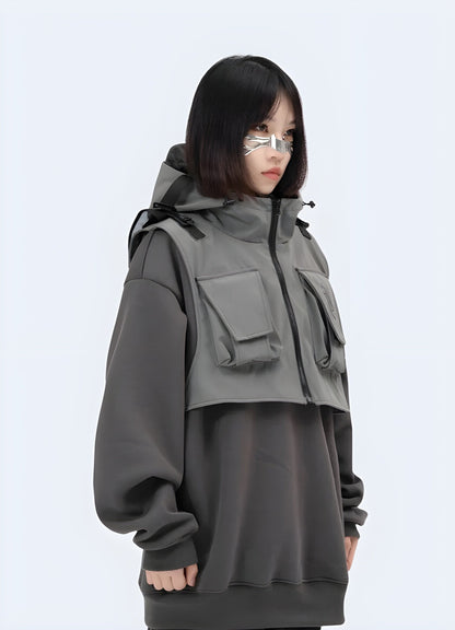 Front side view of a woman wearing a techwear hoodie jacket, showcasing its practical design and contemporary aesthetics for city life in the UK.