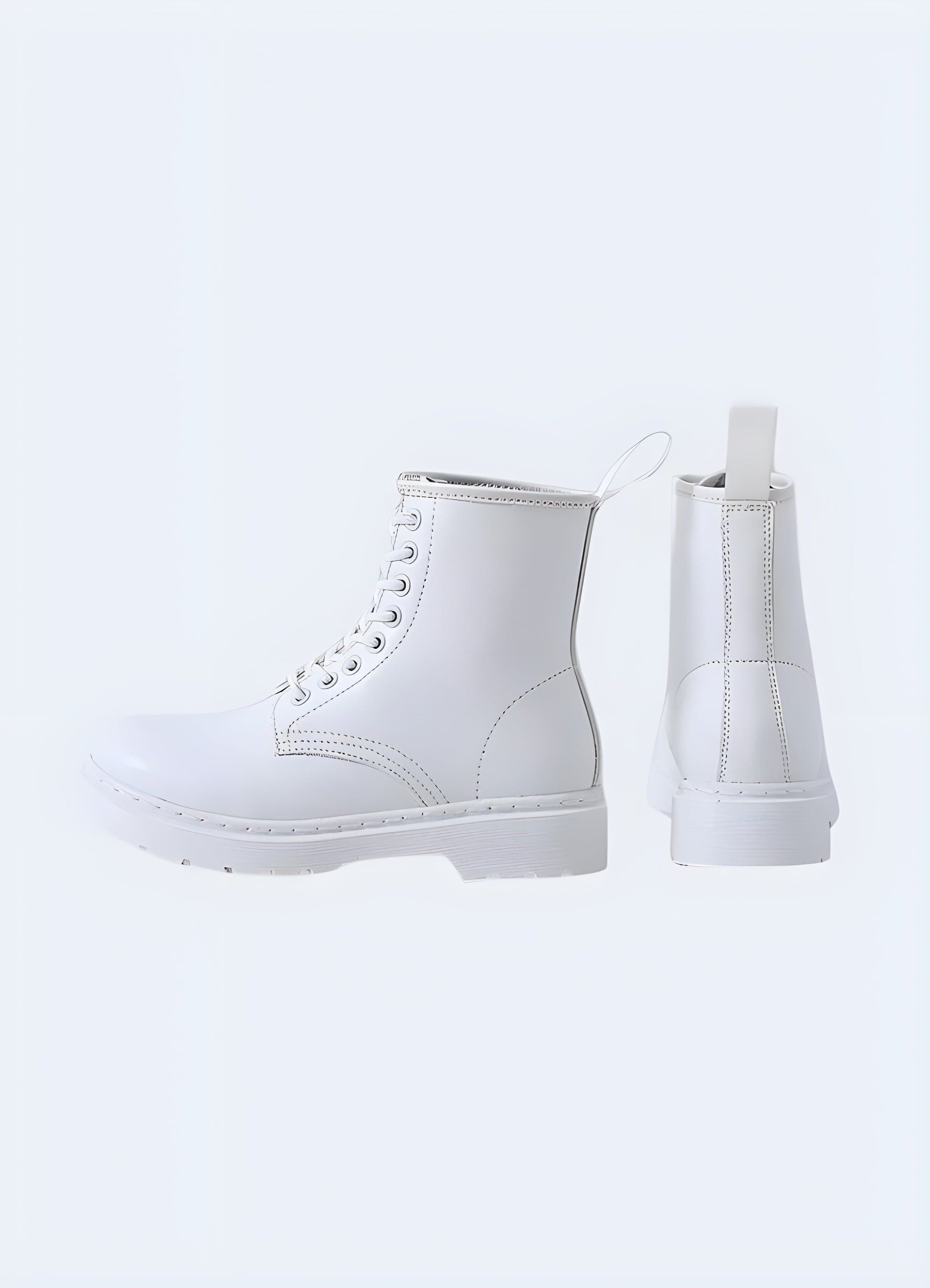 Back and side view of white combat boots, showcasing the sturdy construction, chunky sole, and military-inspired design for a bold fashion statement.