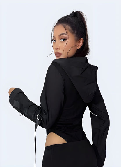 Back view of a woman in a chic black hoodie bodysuit, highlighting its unique design features and practicality for UK urban fashion.