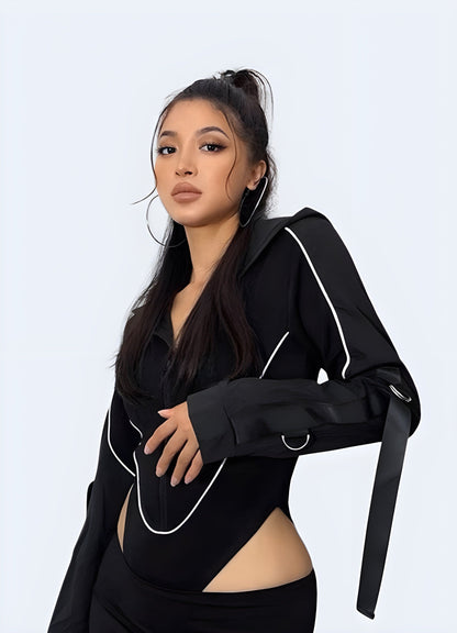 Front side view of a woman wearing a cutting-edge black hoodie bodysuit, demonstrating its modern aesthetic and functionality for UK fashion-forward individuals.