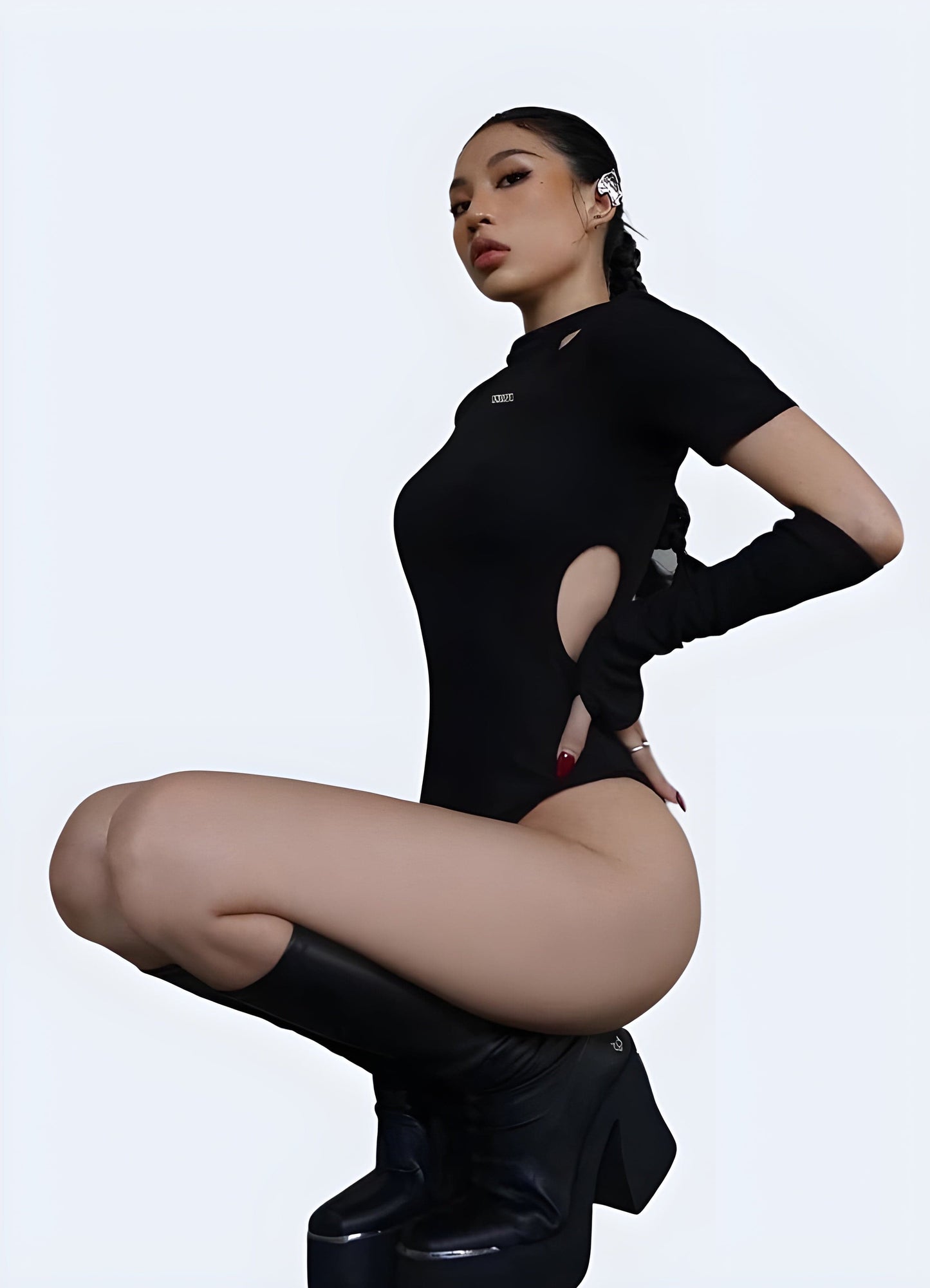 Side view of a woman wearing a stylish techwear leotard, demonstrating its versatility and modern appeal for UK fashion-forward individuals.