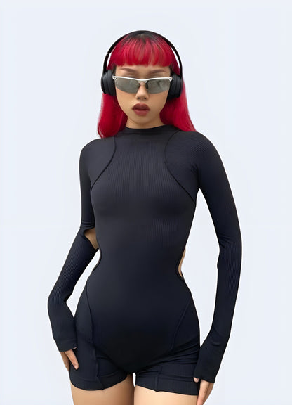 UK model showcasing a front view of a contemporary techwear playsuit, highlighting its sleek lines and modern appeal for urban fashion.