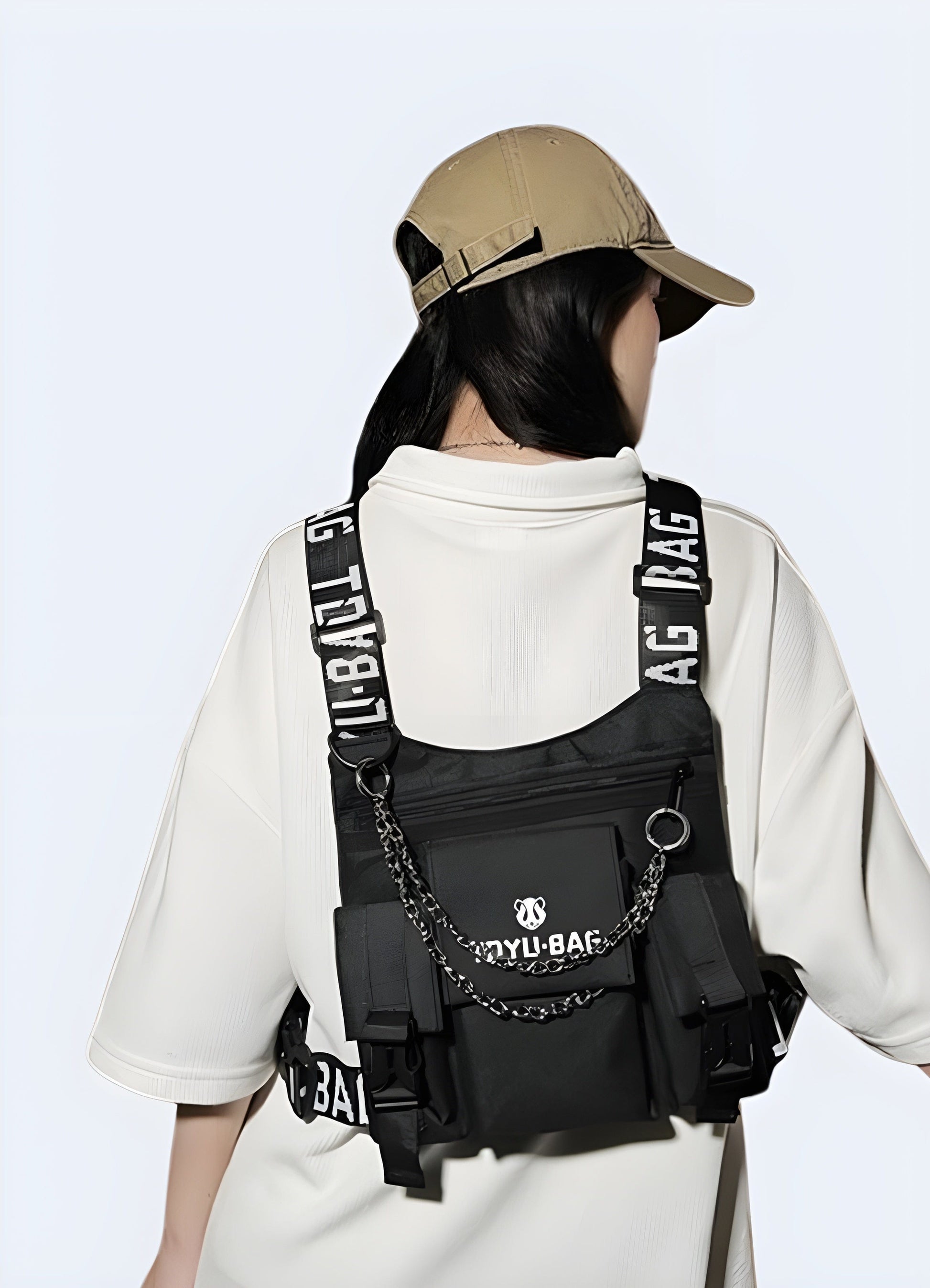 A woman wearing a back-side techwear chest bag in front view, showcasing the versatile and modern design of the bag for urban and outdoor use, UK.