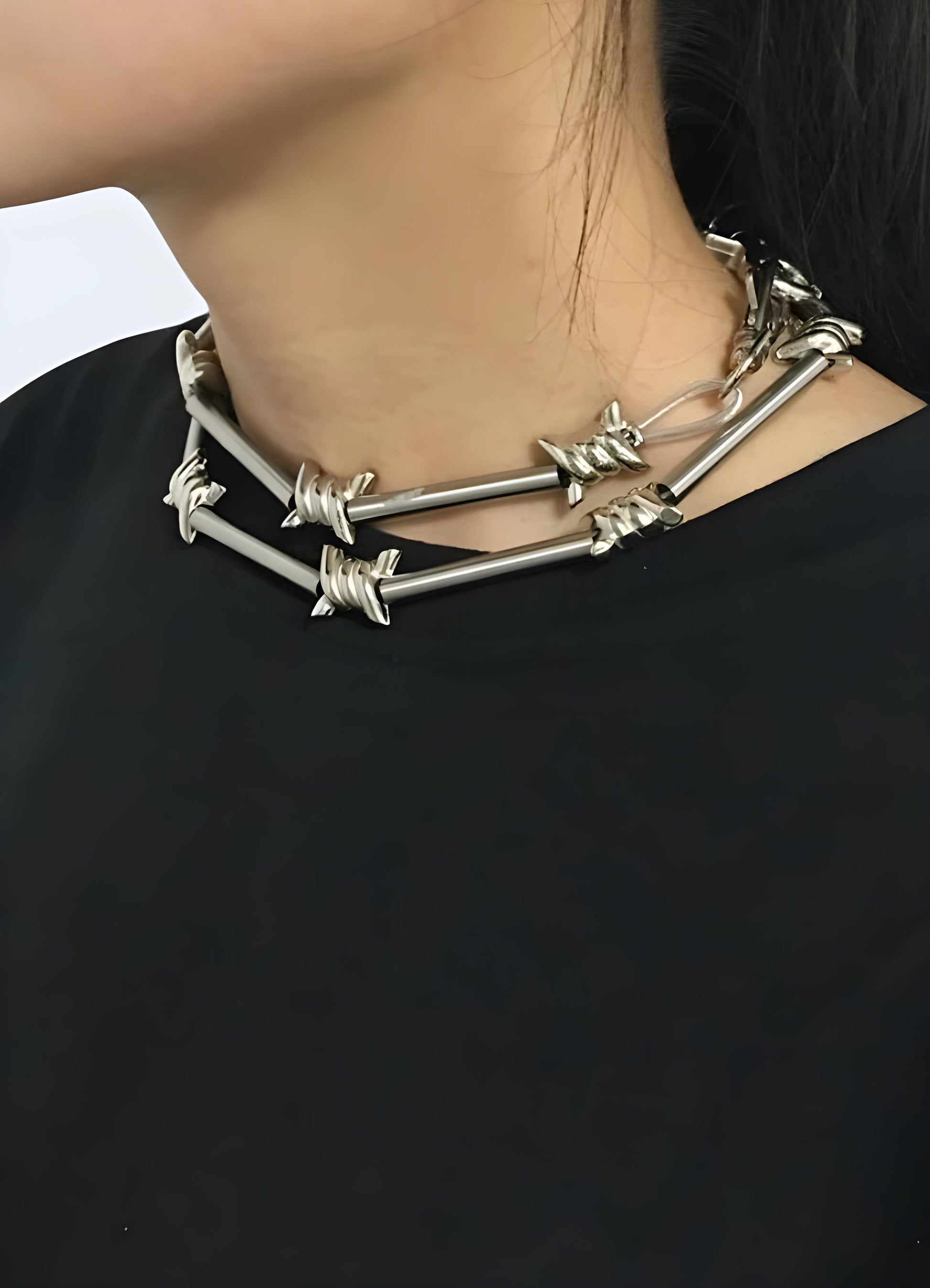 Front view of a woman wearing a barbed wire chain necklace in the UK.