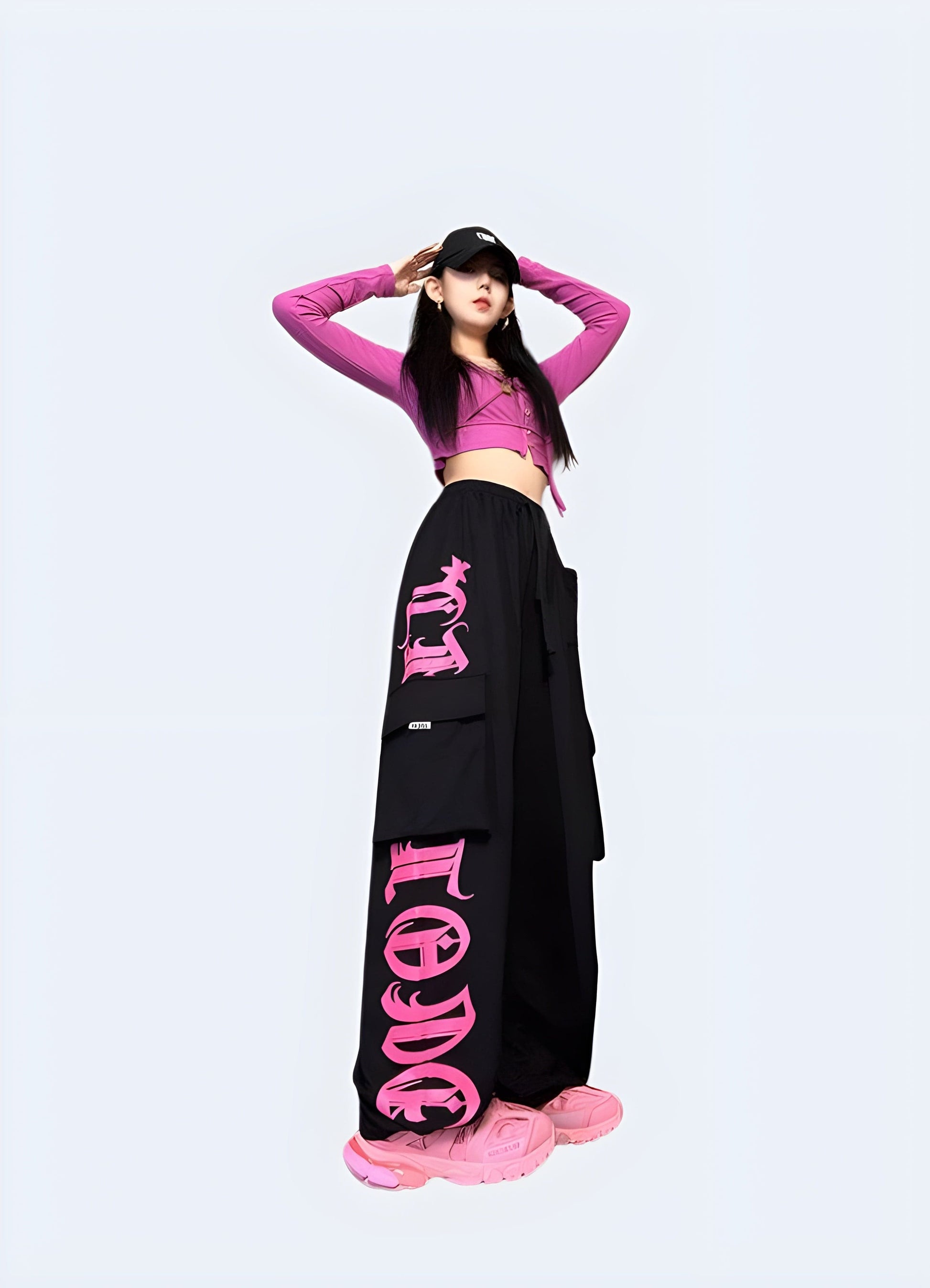 Front side view of a woman wearing trendy black and pink cargo pants, showcasing the unique color combination and practical design popular among UK fashion enthusiasts.