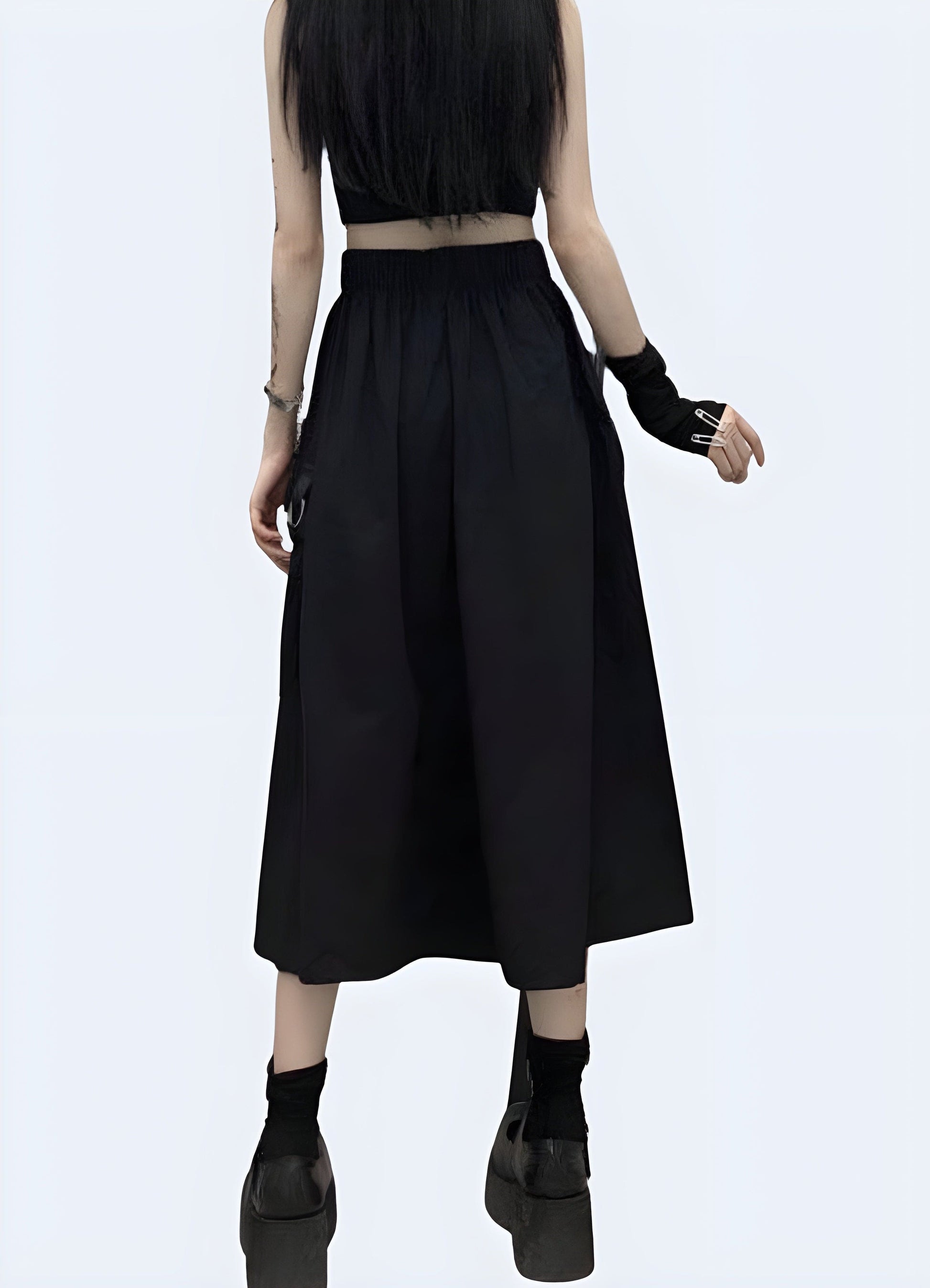 Side view of a woman wearing a black cargo maxi skirt, showcasing its unique pocket details and flattering silhouette for a fashionable yet functional look in the UK.