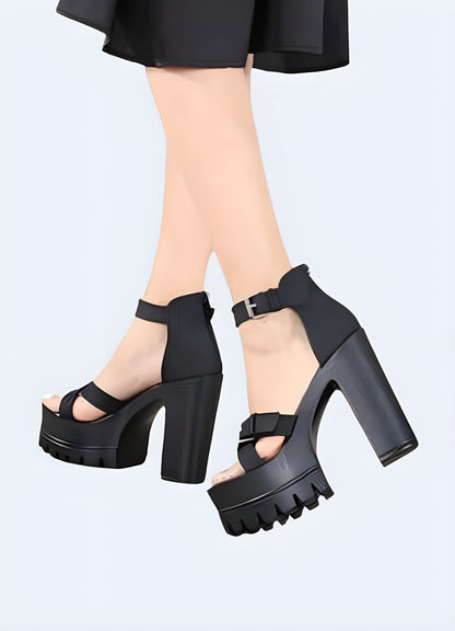 Back and side view of a woman wearing black chunky strap sandals, highlighting the trendy design, secure fit, and fashionable appeal ideal for confident individuals.