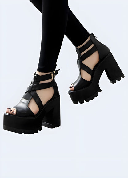 Front and side view of a woman modeling black sandals with a chunky heel, highlighting the eye-catching silhouette, quality materials, and versatile aesthetics suitable for various occasions.